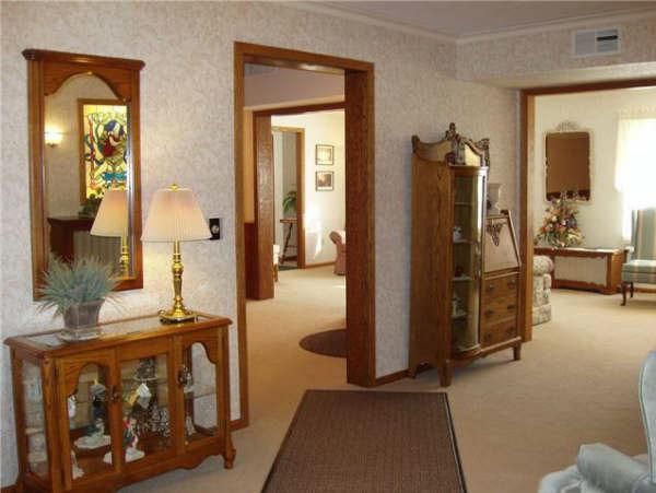 A living room with a lamp and a mirror