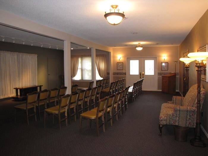 A room with rows of chairs and a lamp