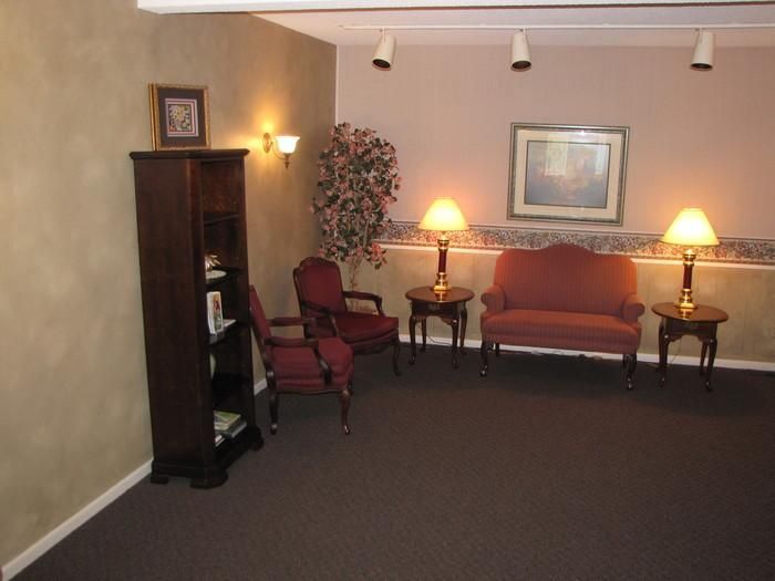 A living room with a couch and chairs and lamps