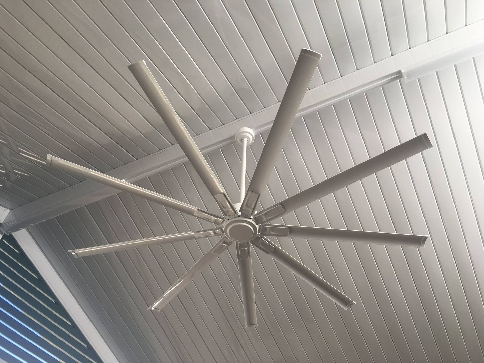 A Large Ceiling Fan is Hanging From the Ceiling of a Building — Himec Electrical In Withcott, QLD