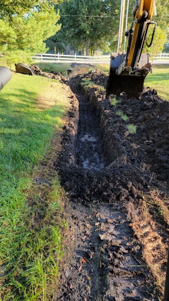 A person is using a shovel to dig a hole in the ground.