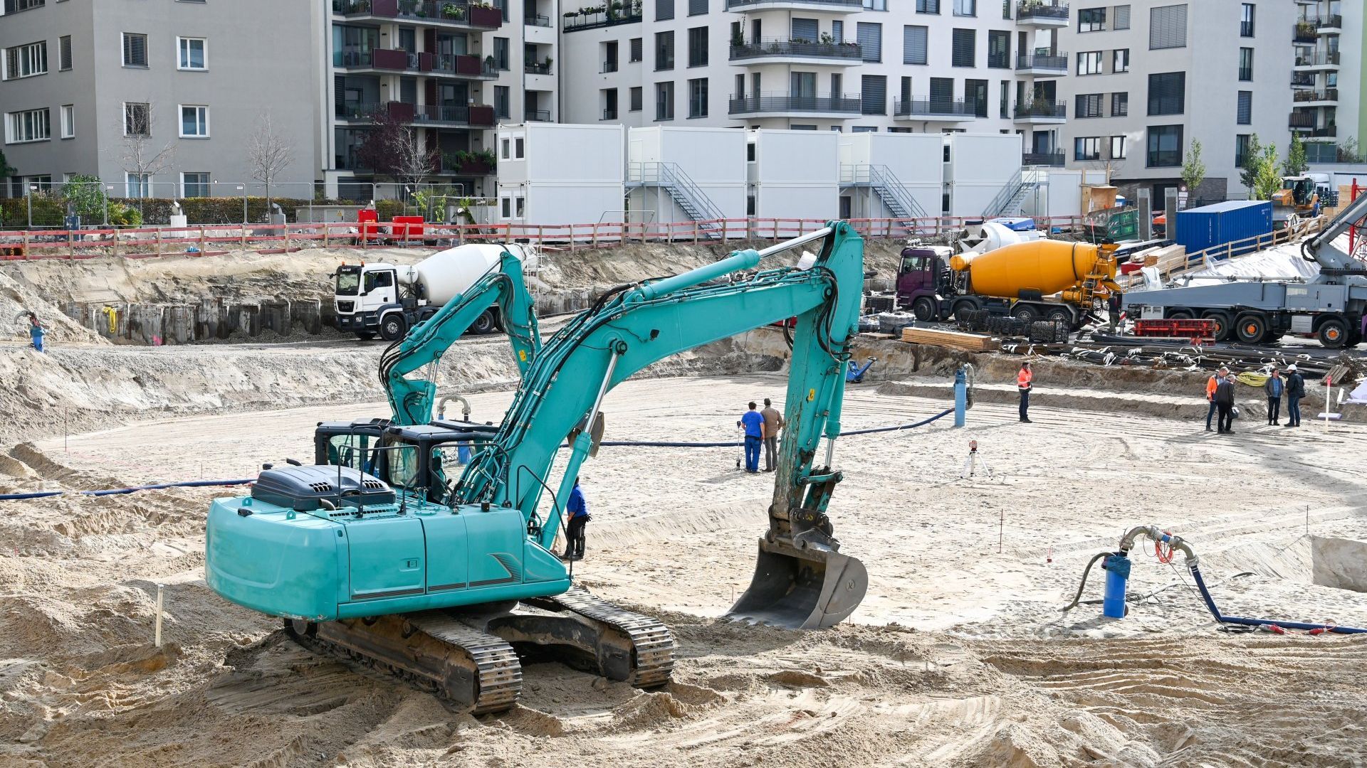 A large excavator is sitting in the middle of a construction site.