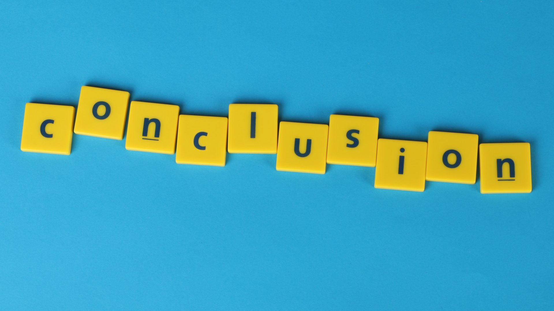 The word conclusion is written in yellow scrabble tiles on a blue background.