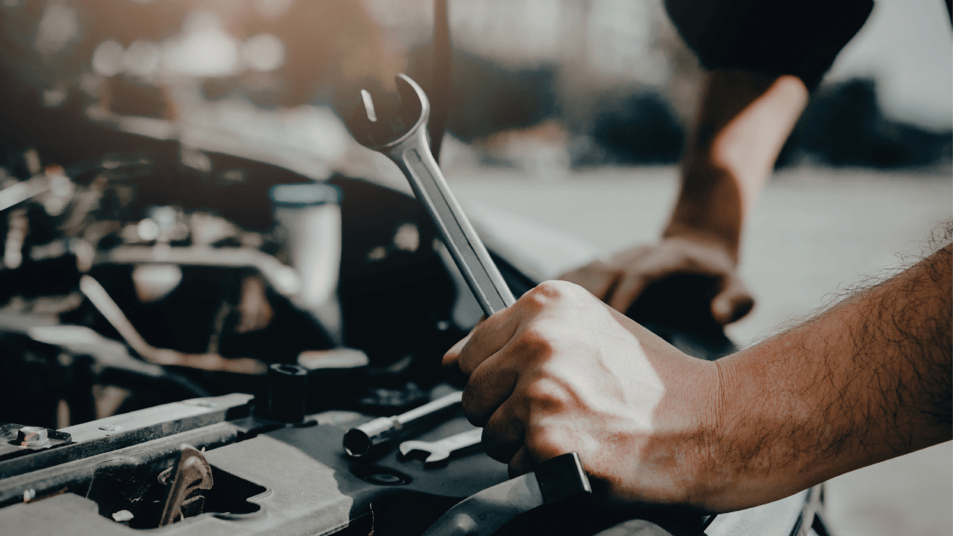 a mobile mechanic holding a wrench
