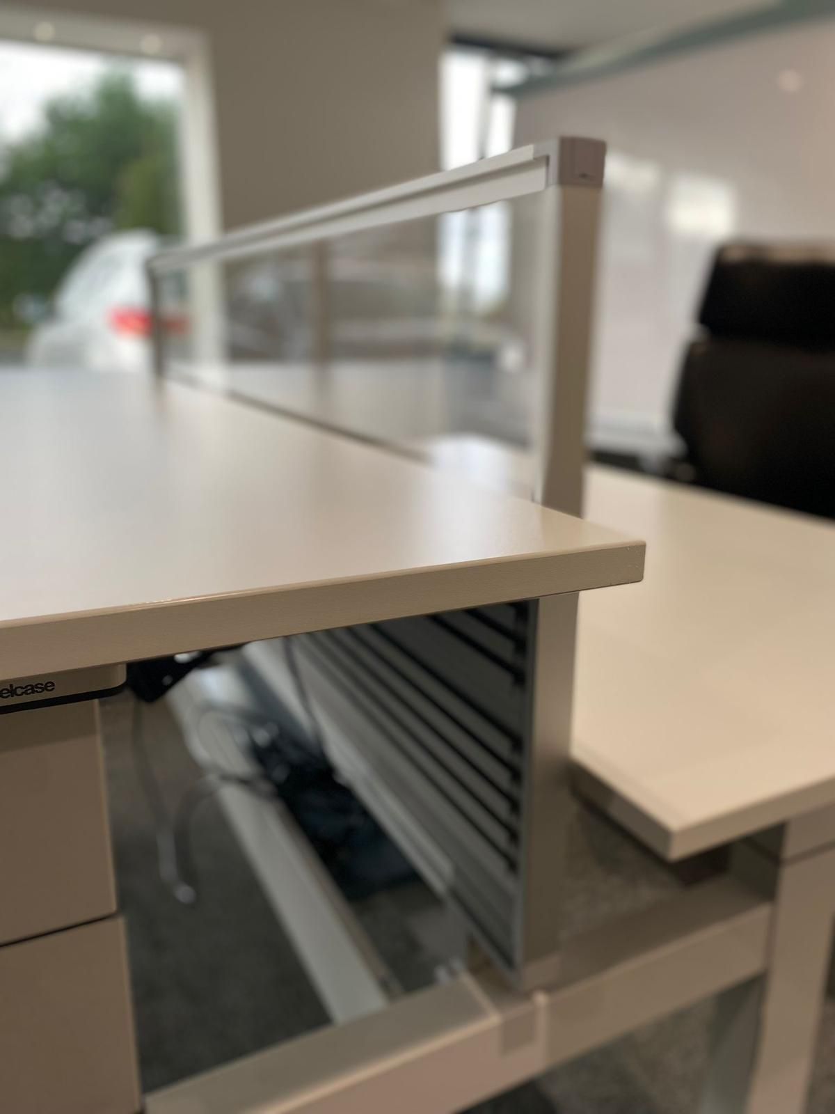 White office desk with a transparent divider and drawer.