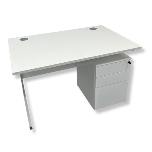 White office desk with three-drawer cabinet and two circular grommet holes.