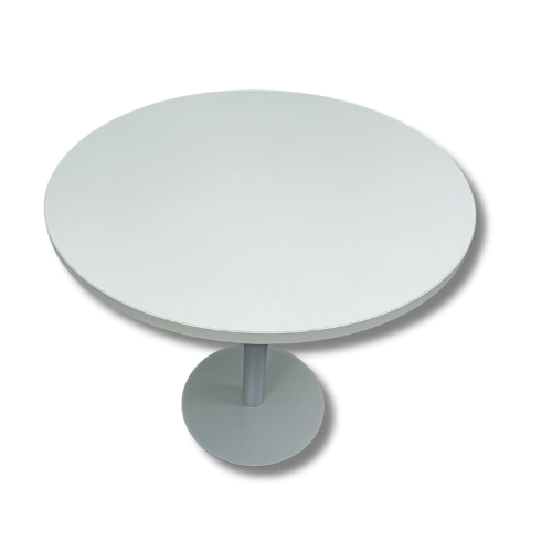 White round table with a single pedestal base, casting a shadow.