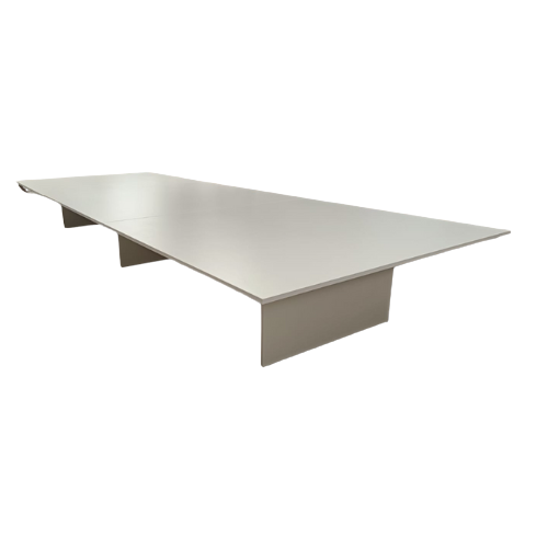 A long, rectangular conference table with gray tabletop and beige pedestal legs.
