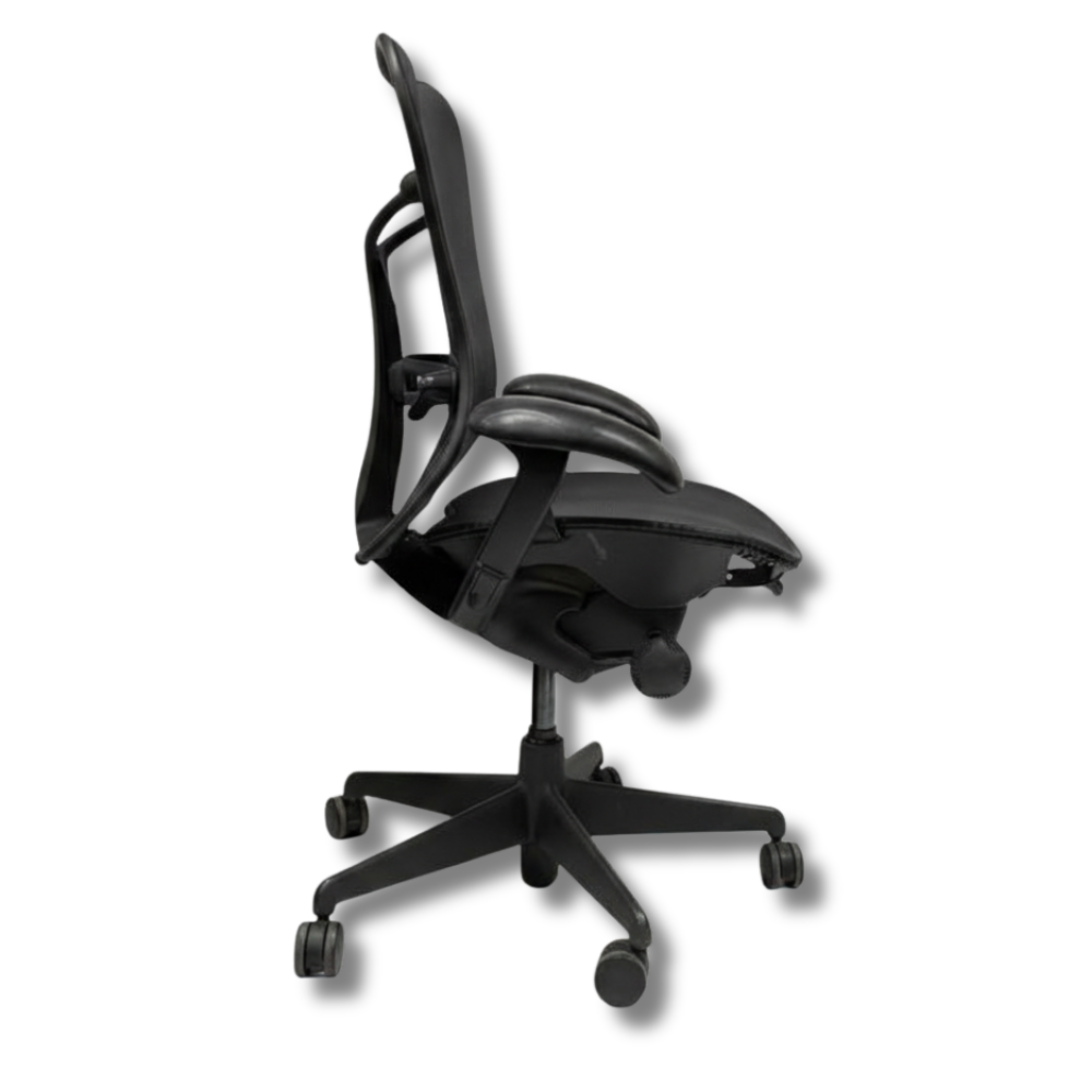 Used Herman Miller Aeron Black ergonomic office chair, side view. Mesh back and seat, armrests, five-star base with wheels.