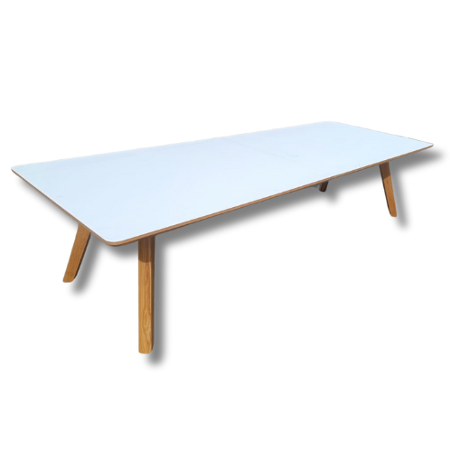White rectangular table with light wood legs.
