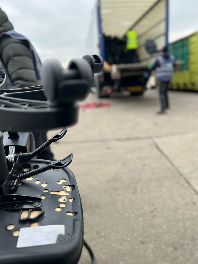 A trade load of office chairs being unloaded from an articulated trailer