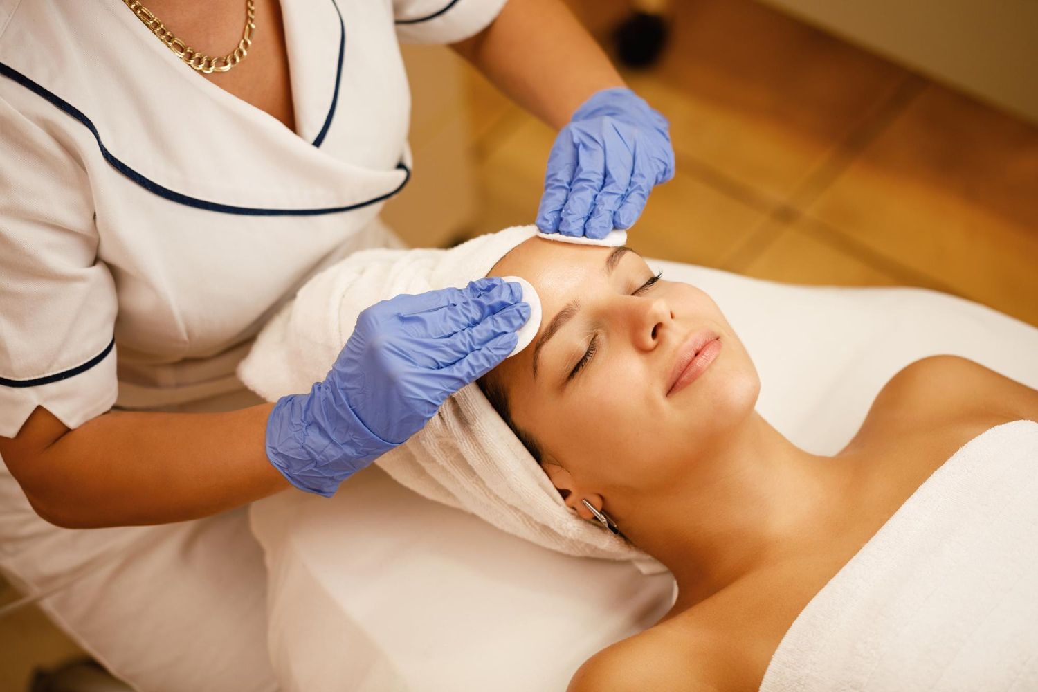 A woman is getting a facial treatment at a spa.