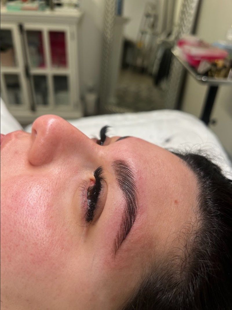 A close up of a woman 's face with long eyelashes.