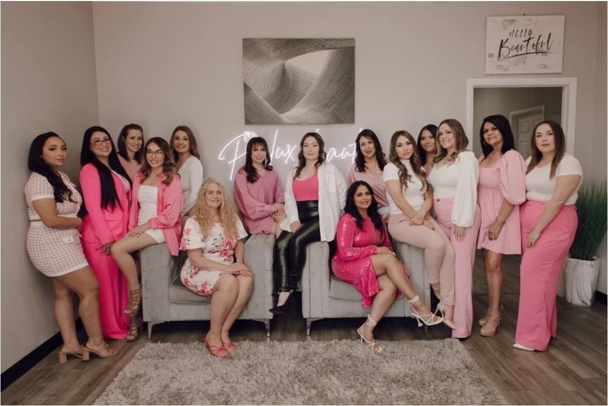 A group of women are posing for a picture in a living room.