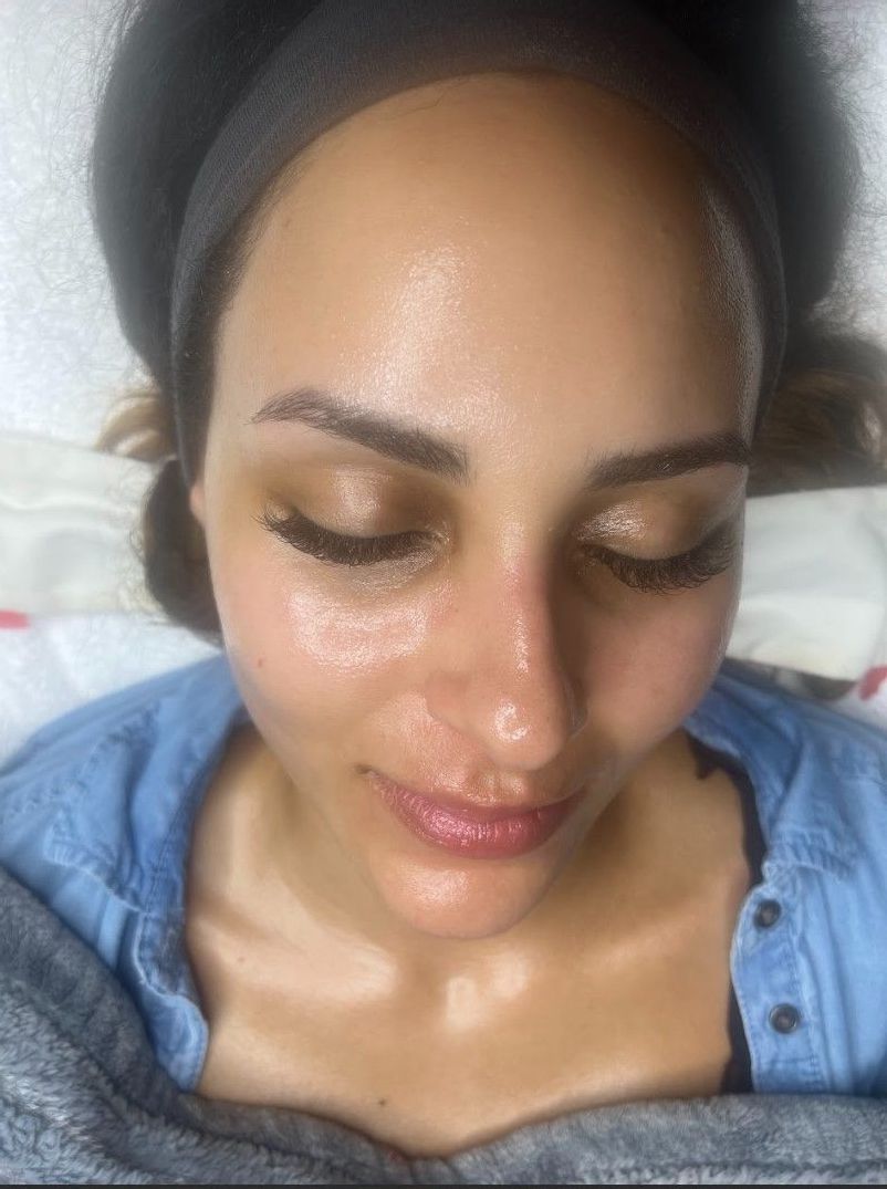 A close up of a woman 's face with her eyes closed.