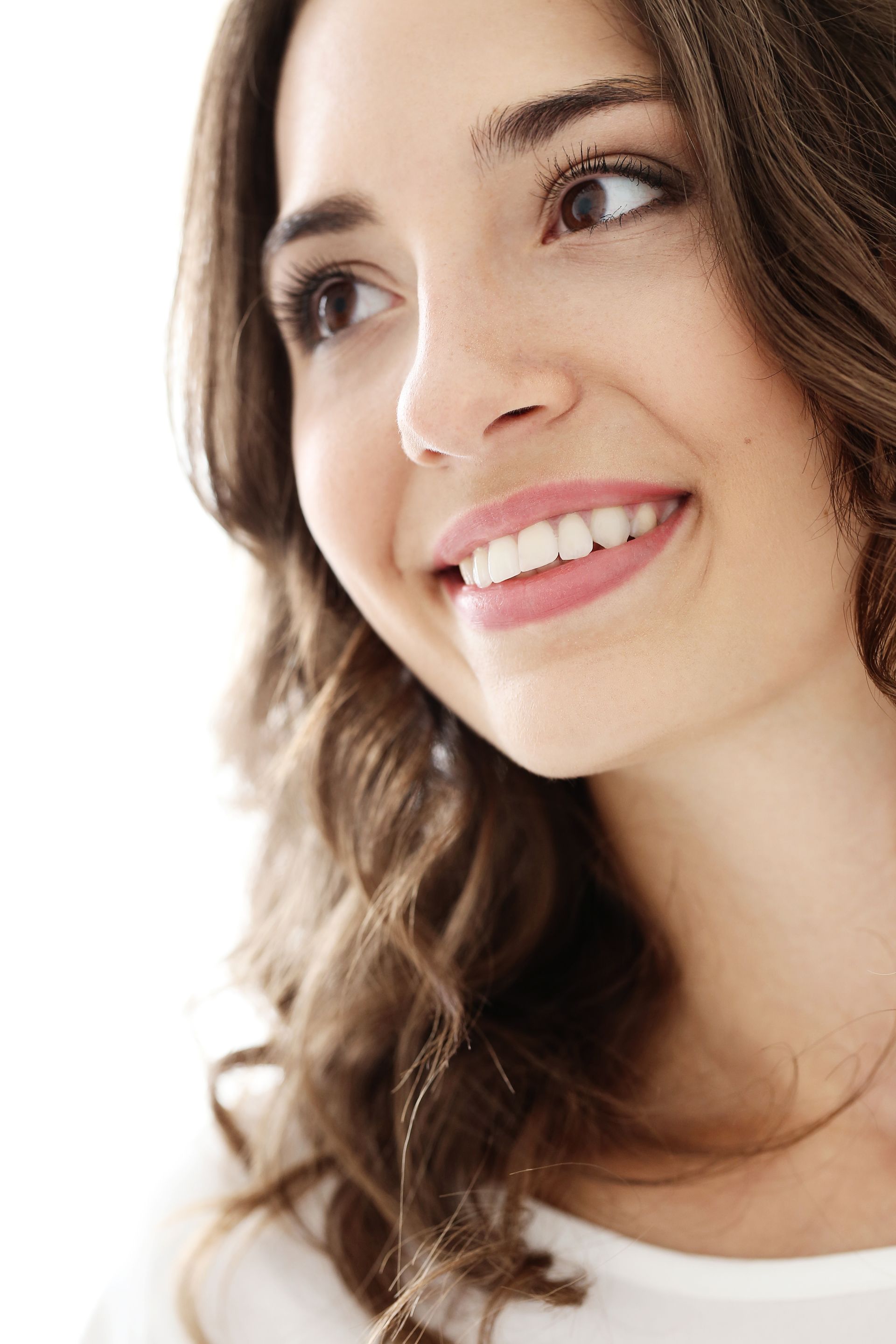 A close up of a woman 's face with a smile on her face.
