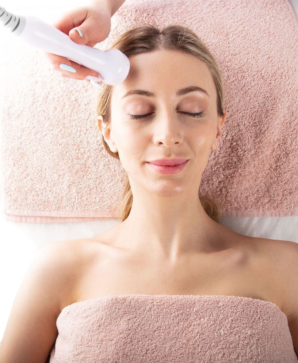 A woman is getting a facial treatment at a spa.