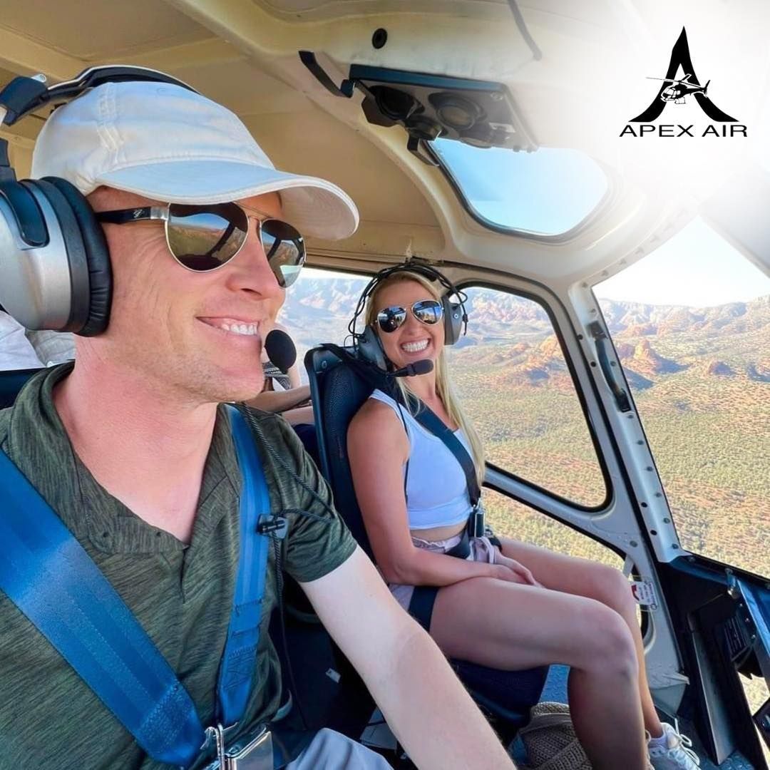 A Man and A Woman Are Sitting in A Helicopter - Kissimmee, FL - Apex Air Tours