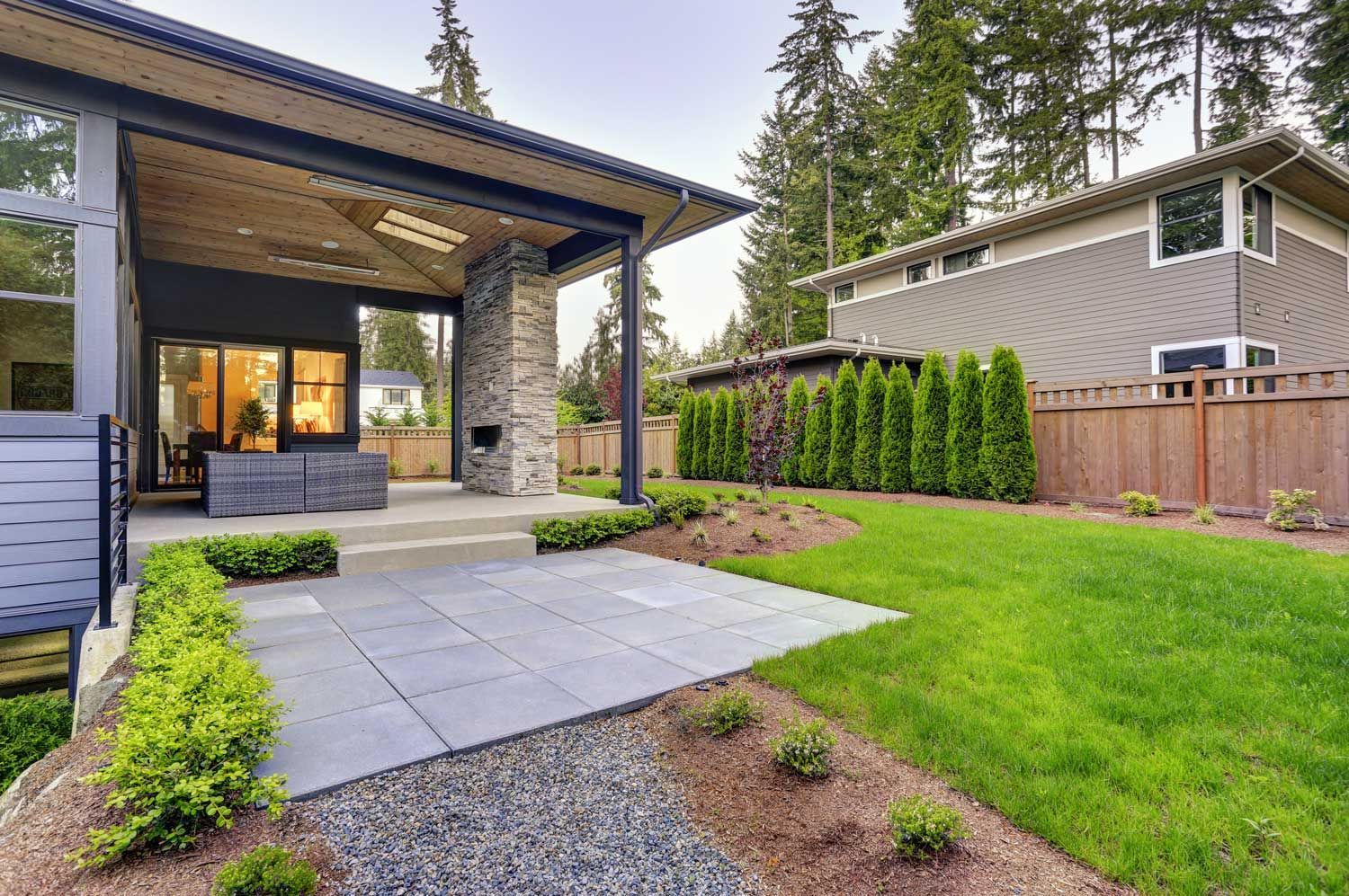 New modern home features a backyard with patio cover.