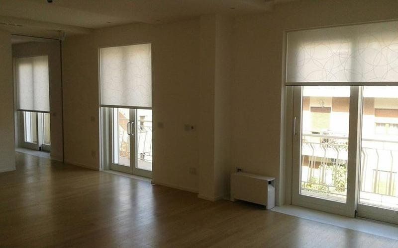 Stanza con parquet e porte finestre bianche