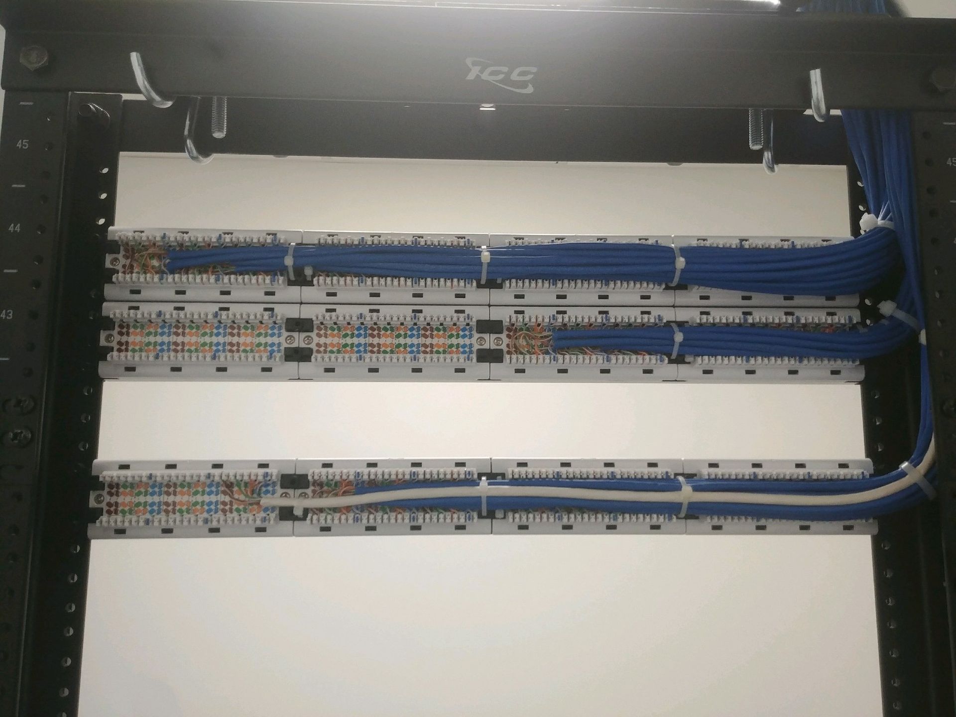 A server rack with a lot of wires coming out of it