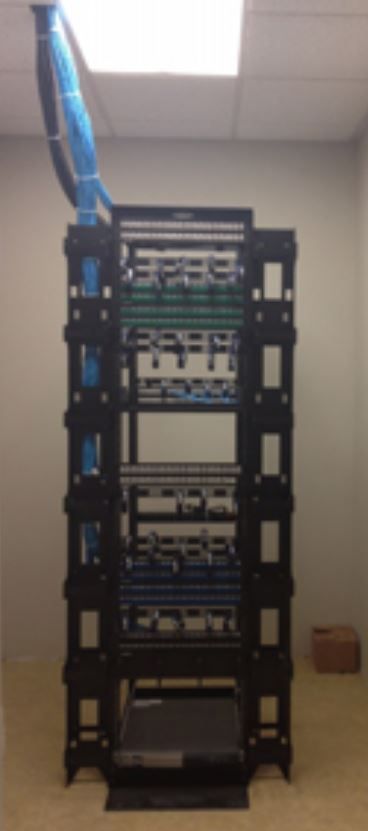 A server rack with blue wires hanging from the ceiling