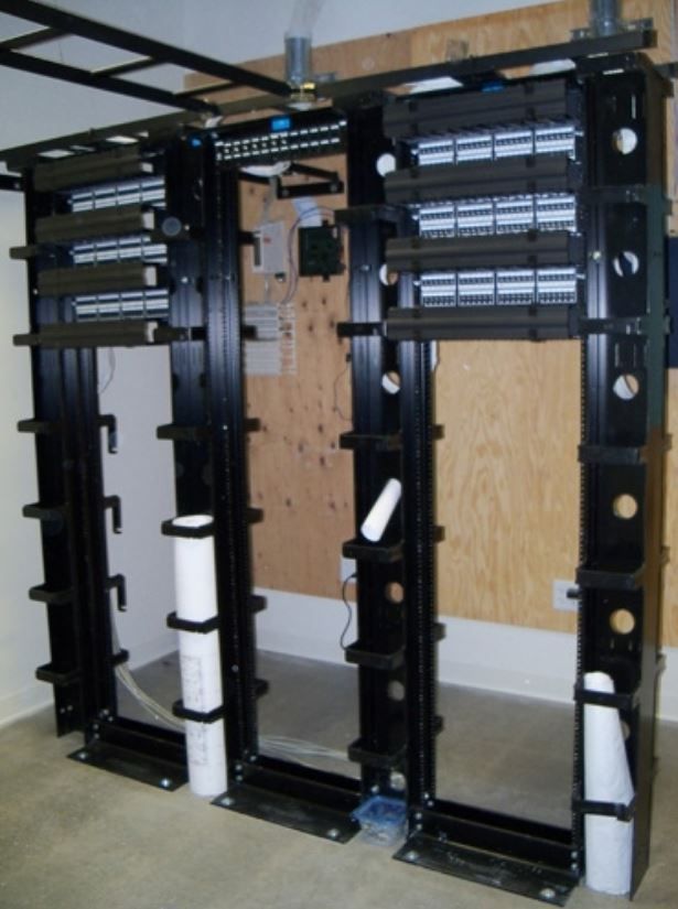 A row of black racks are lined up in a room