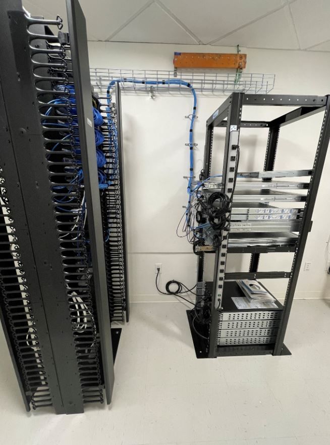 A server rack with a lot of wires coming out of it