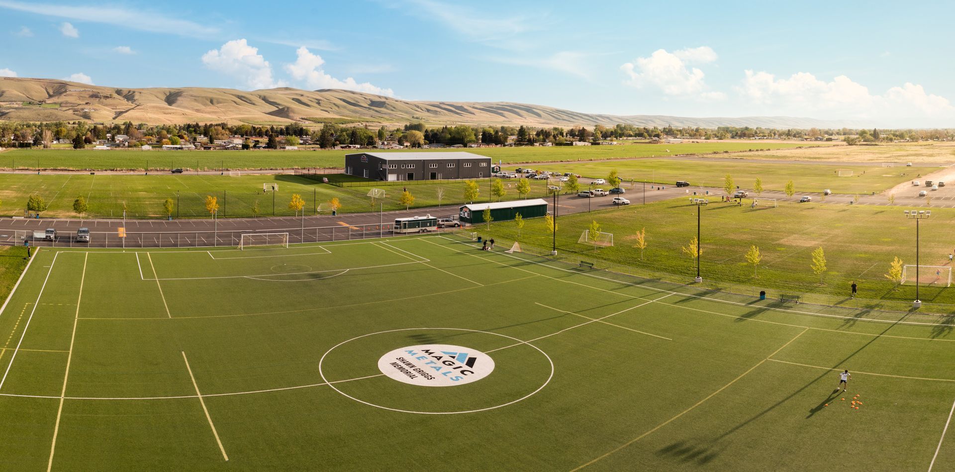 An aerial view of a soccer field with yakima mountains in the background.