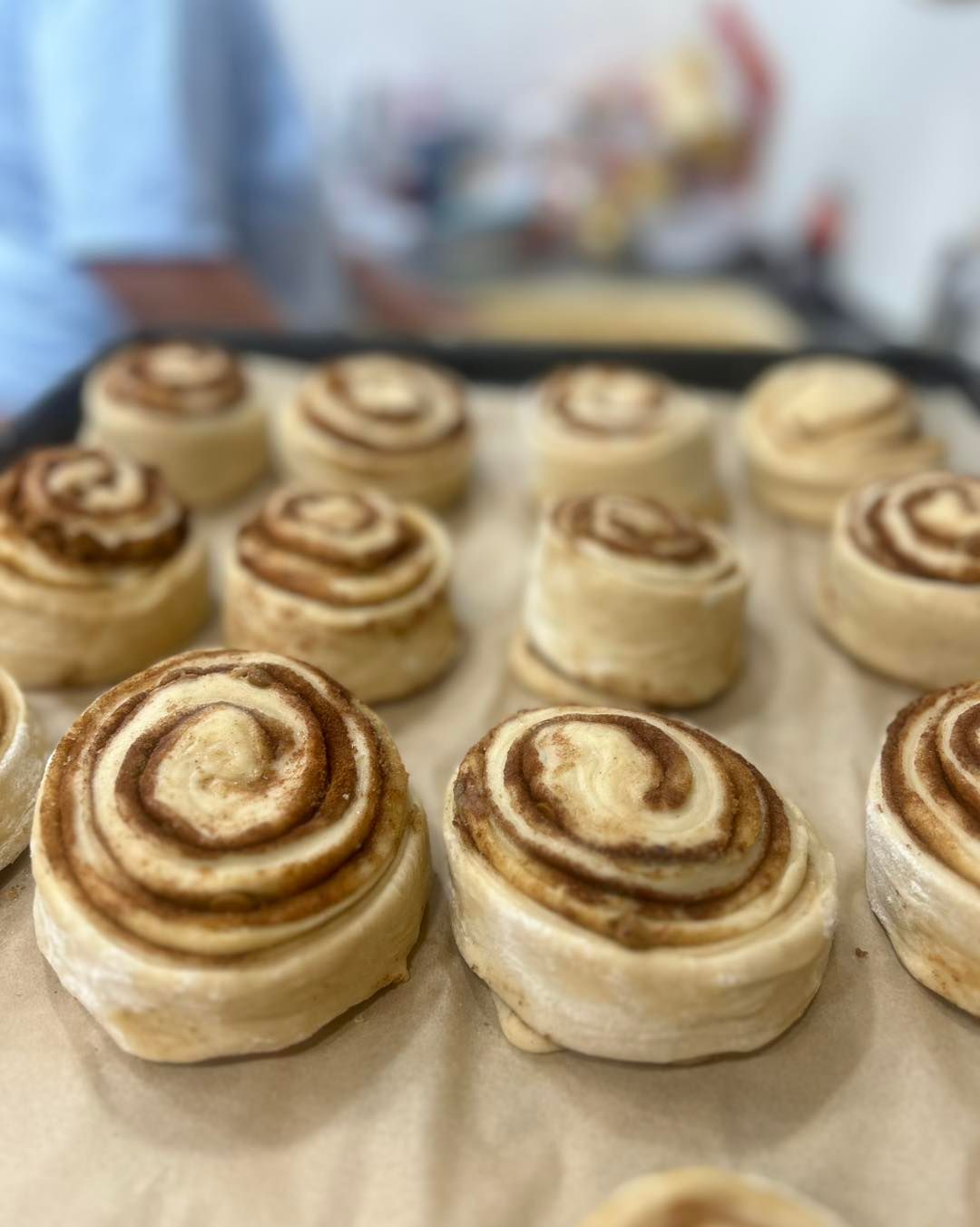 A bunch of cinnamon rolls are sitting on a table