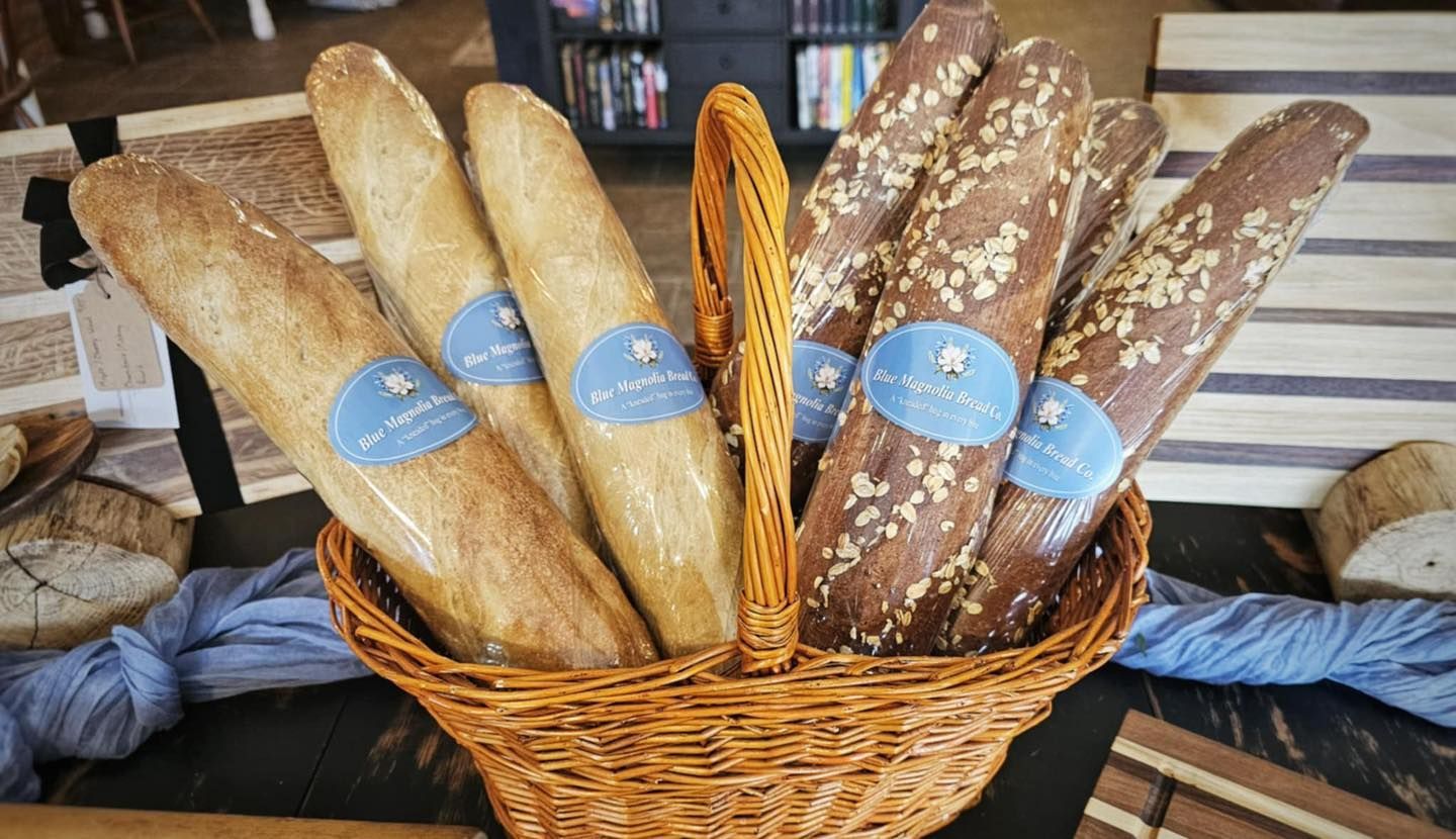 A basket filled with bread sticks on a table.