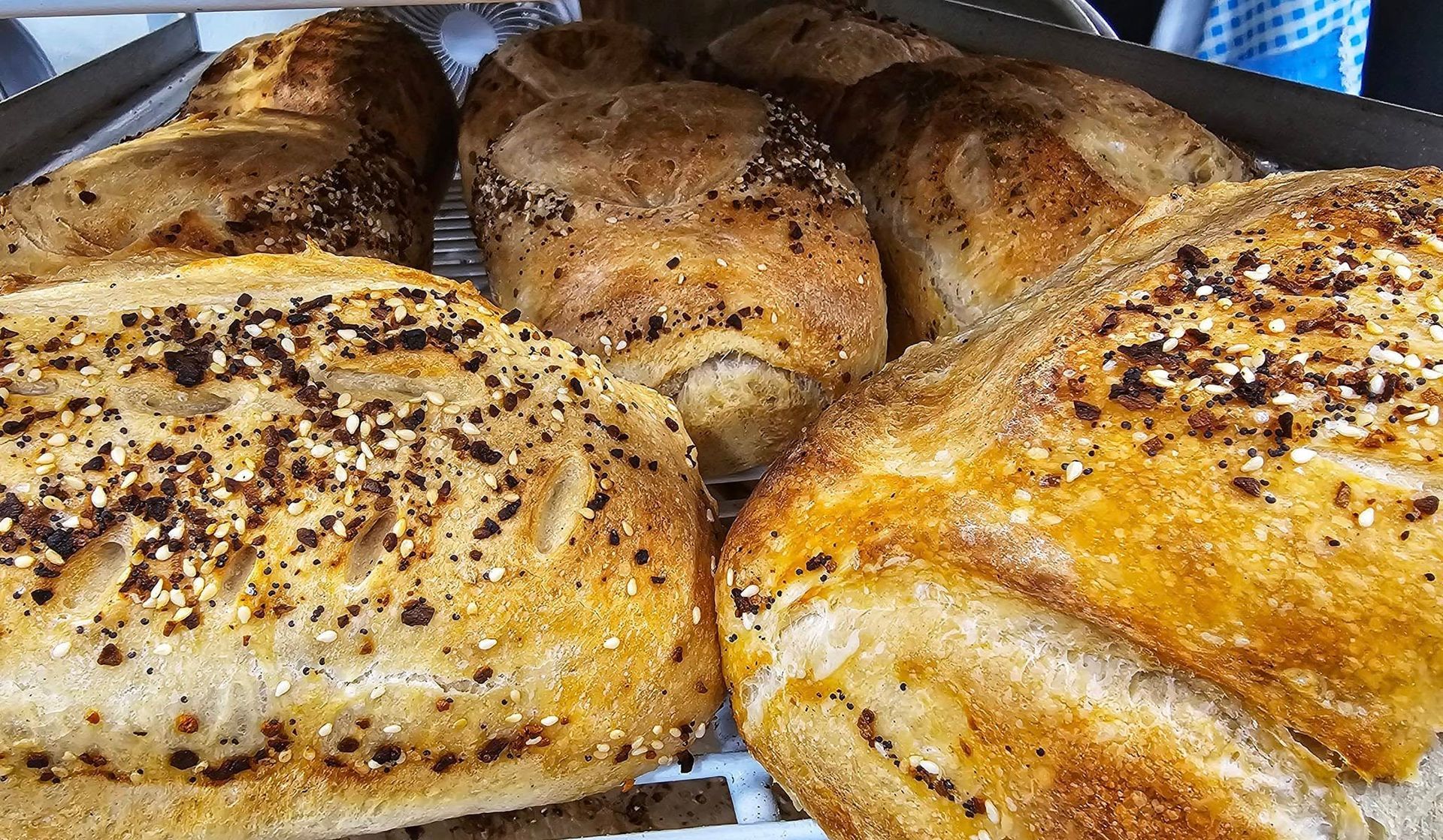 A bunch of bread is sitting on top of each other on a table.
