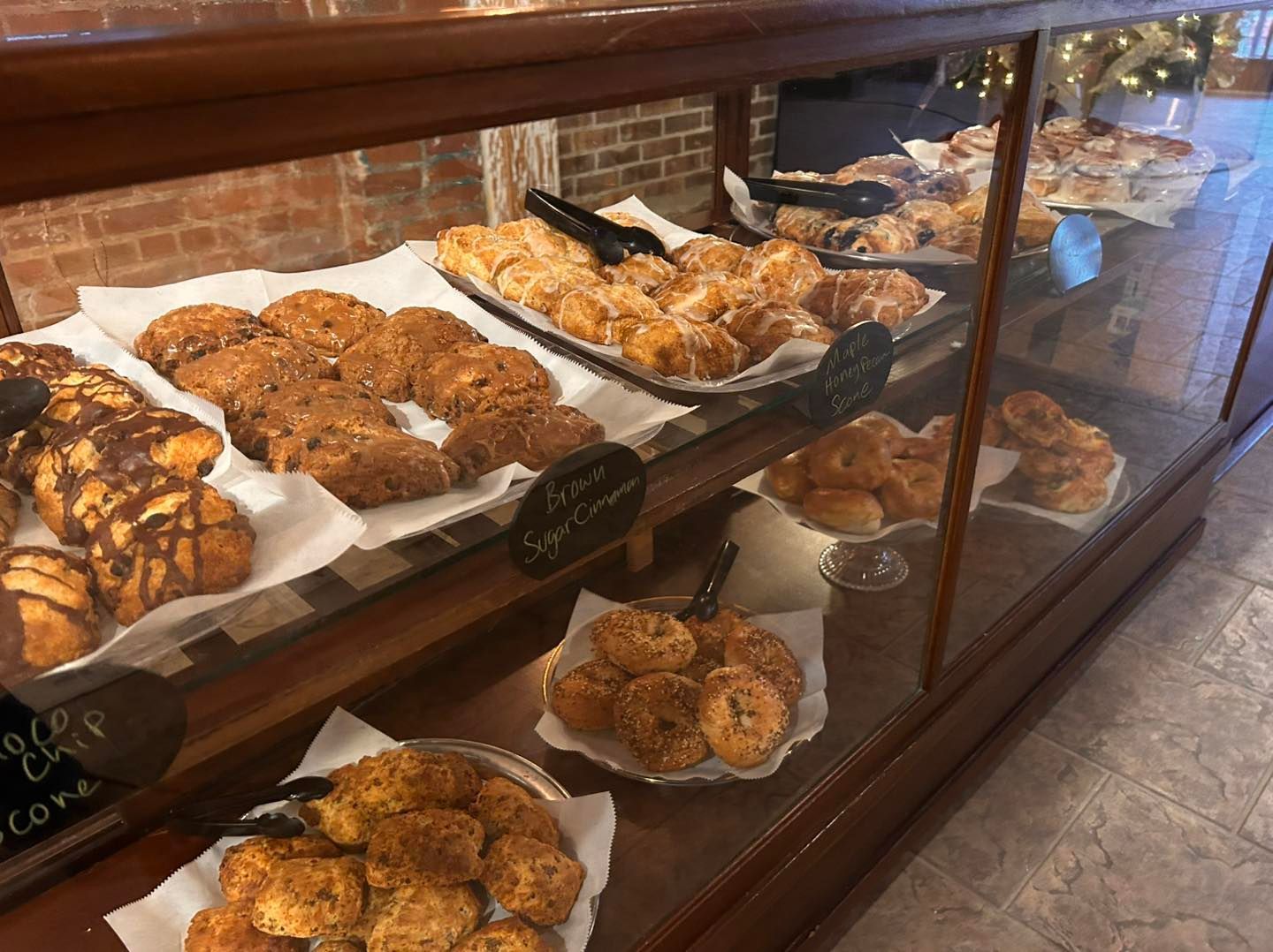 A display case filled with a variety of pastries in a bakery.