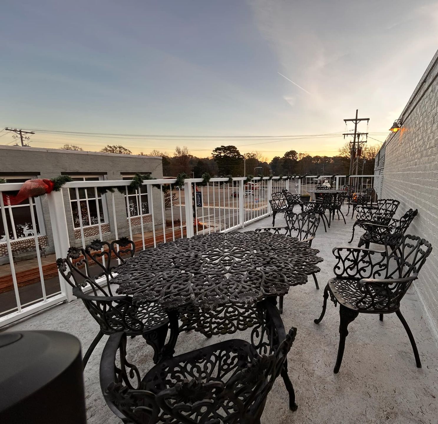 A balcony with a table and chairs on it