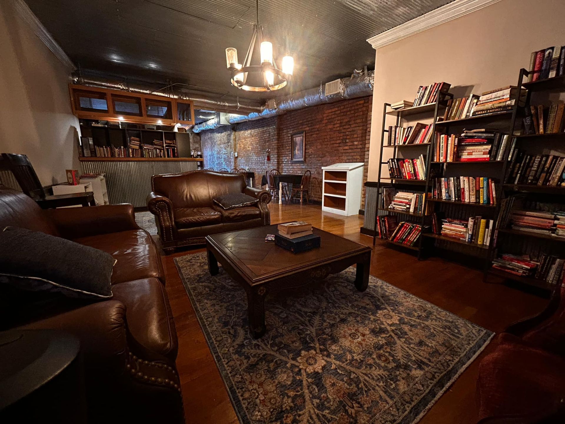 A living room filled with furniture and bookshelves.