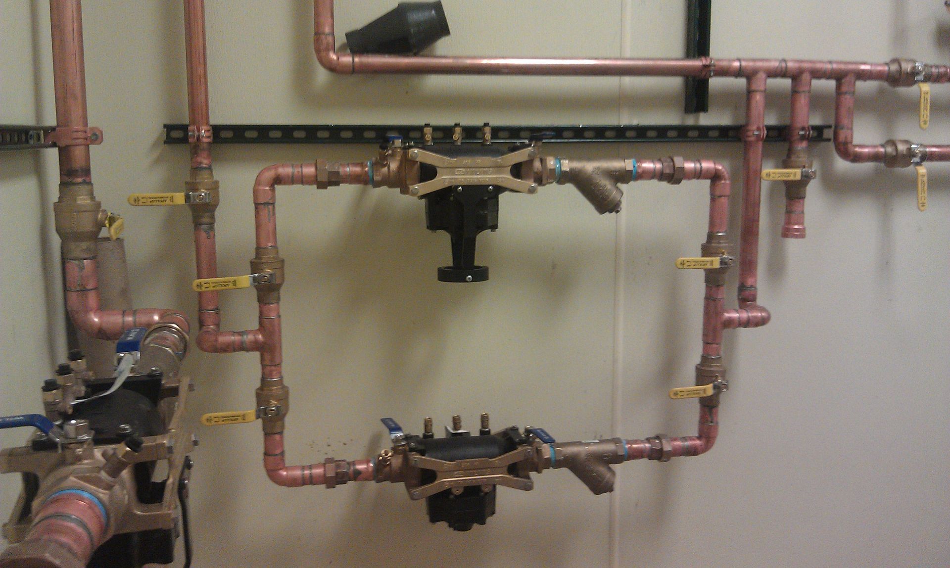 A bunch of copper pipes are hanging on a wall