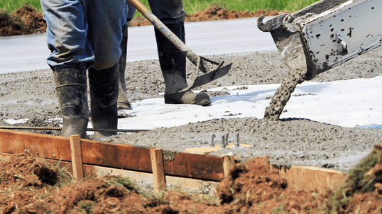 Concrete contractor finishing up a driveway in blaine, mn