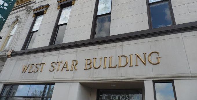 The west star building is a large building with a lot of windows.