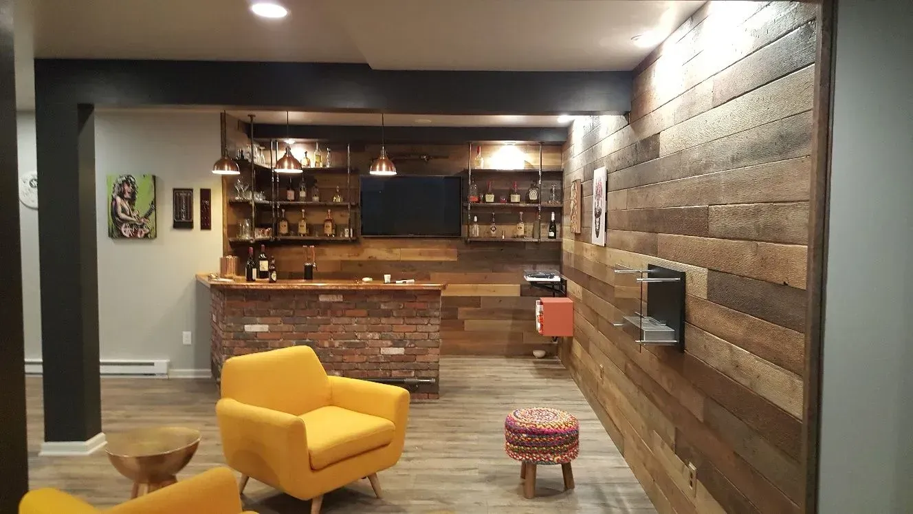 A living room with two yellow chairs and a bar.