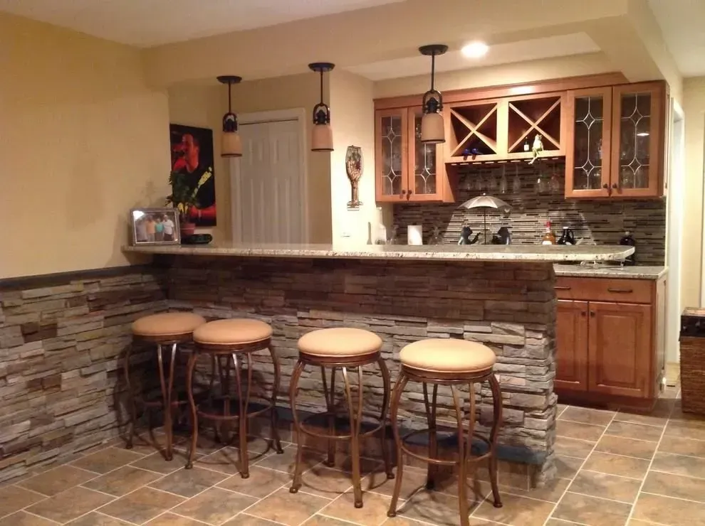 A kitchen with a bar and stools in it