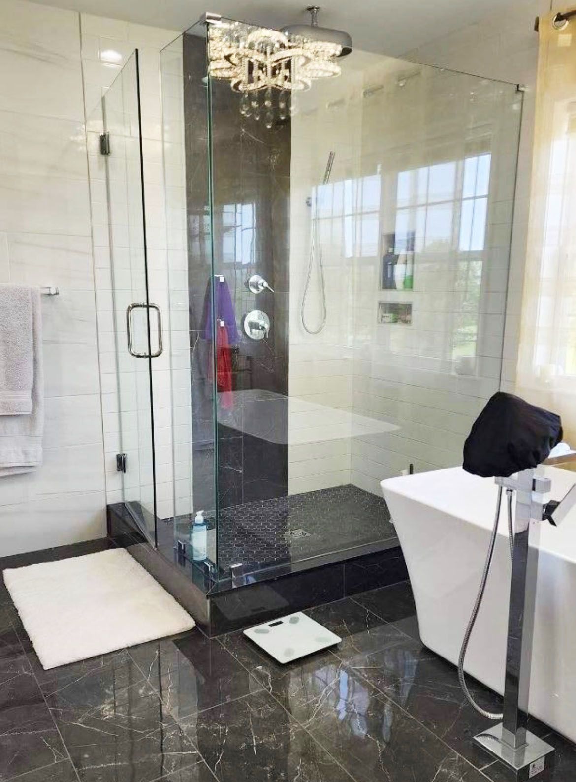 A bathroom with a walk in shower and a bathtub.