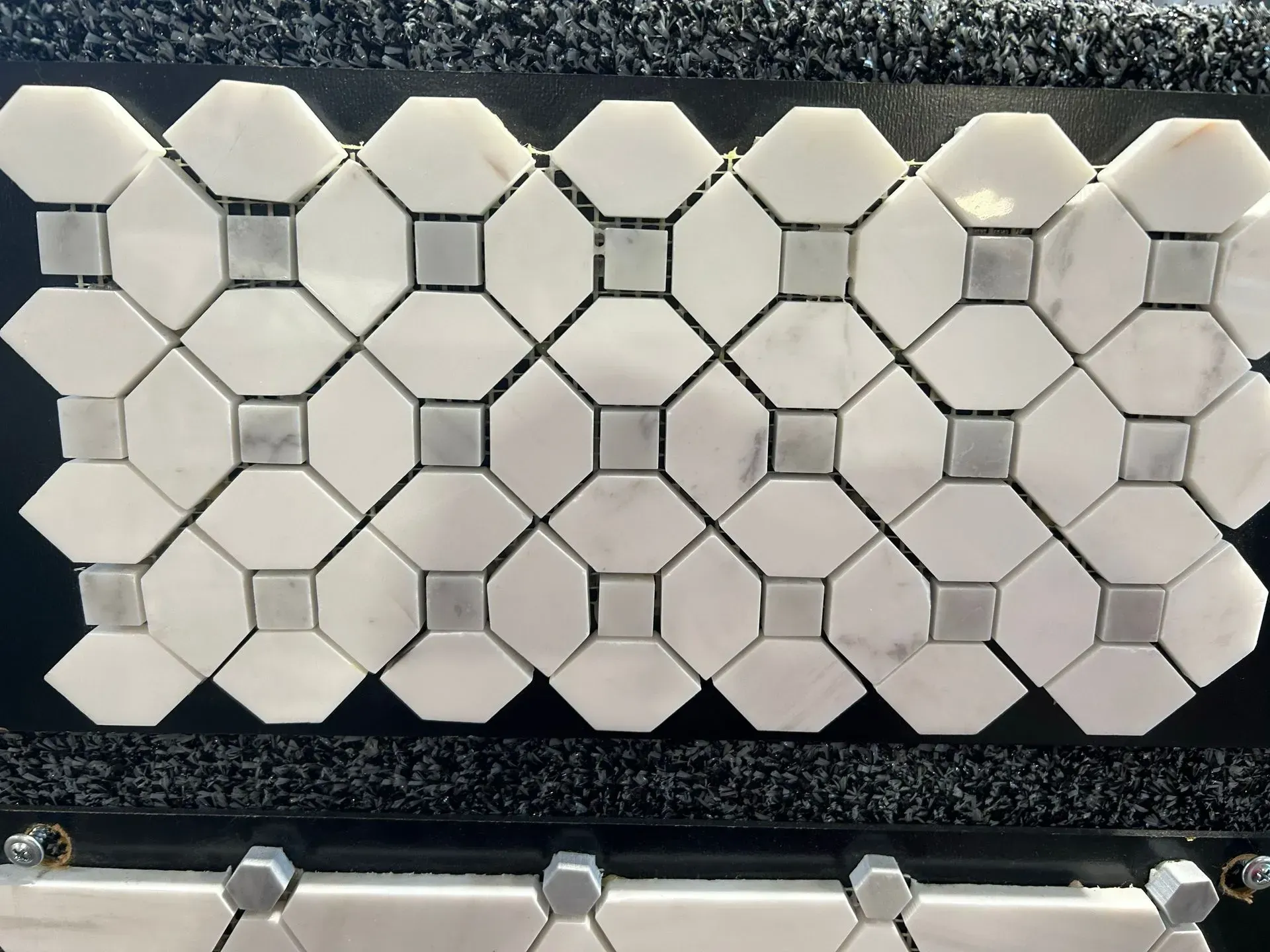 A close up of a white tile with squares on it
