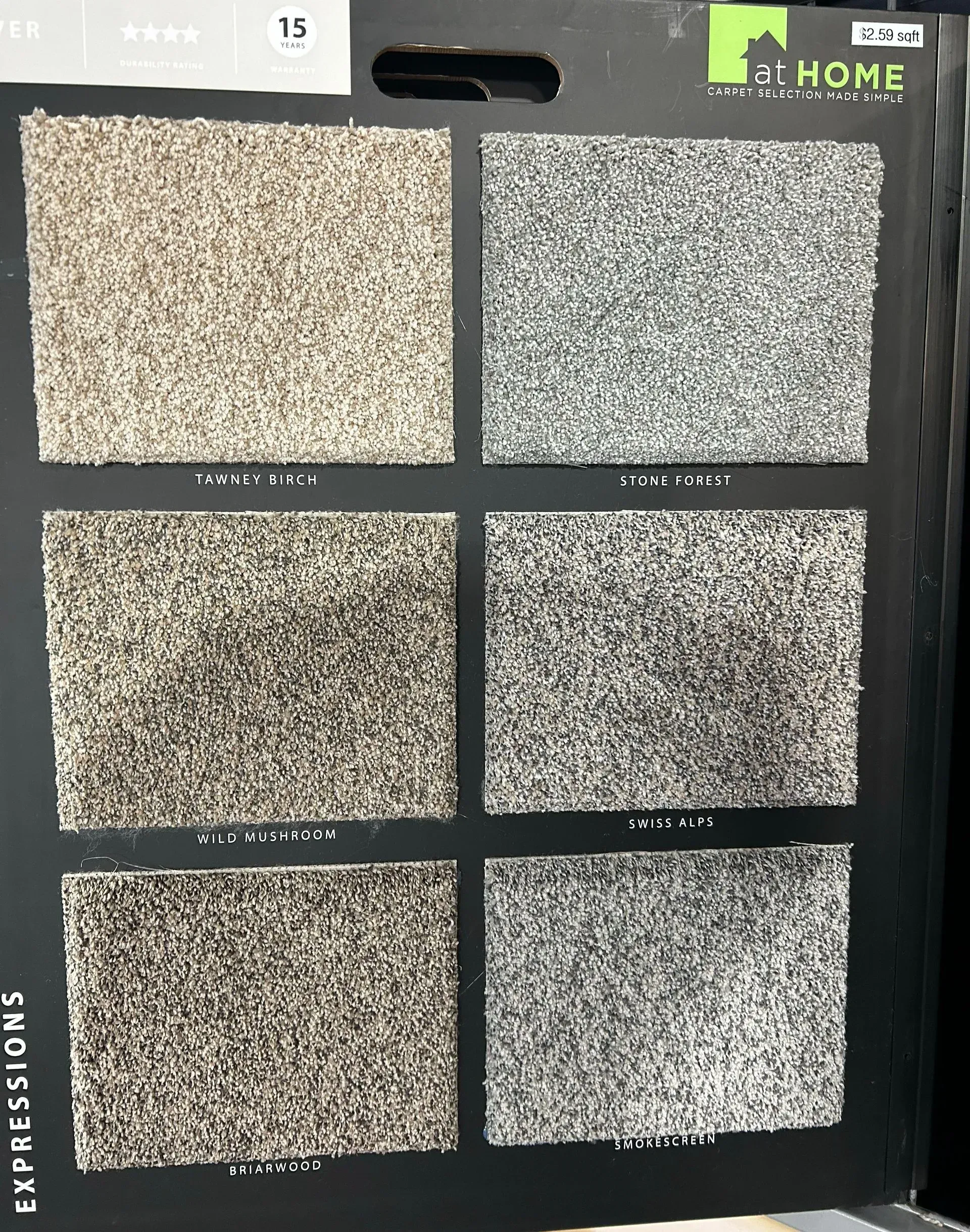 A display of different colored carpets on a black board