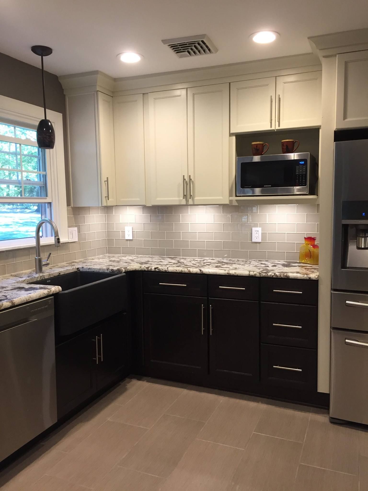 A kitchen with stainless steel appliances and white cabinets