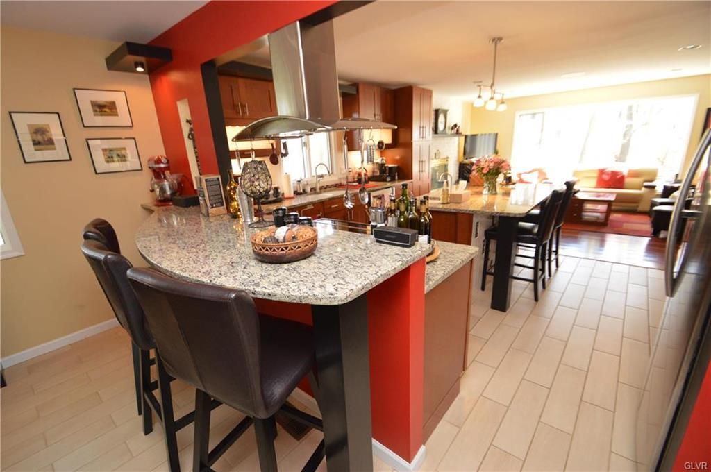 A kitchen with granite counter tops and stainless steel appliances