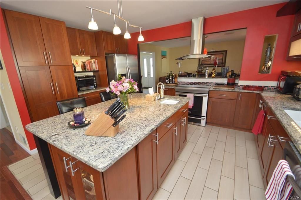 A kitchen with a large island and granite counter tops