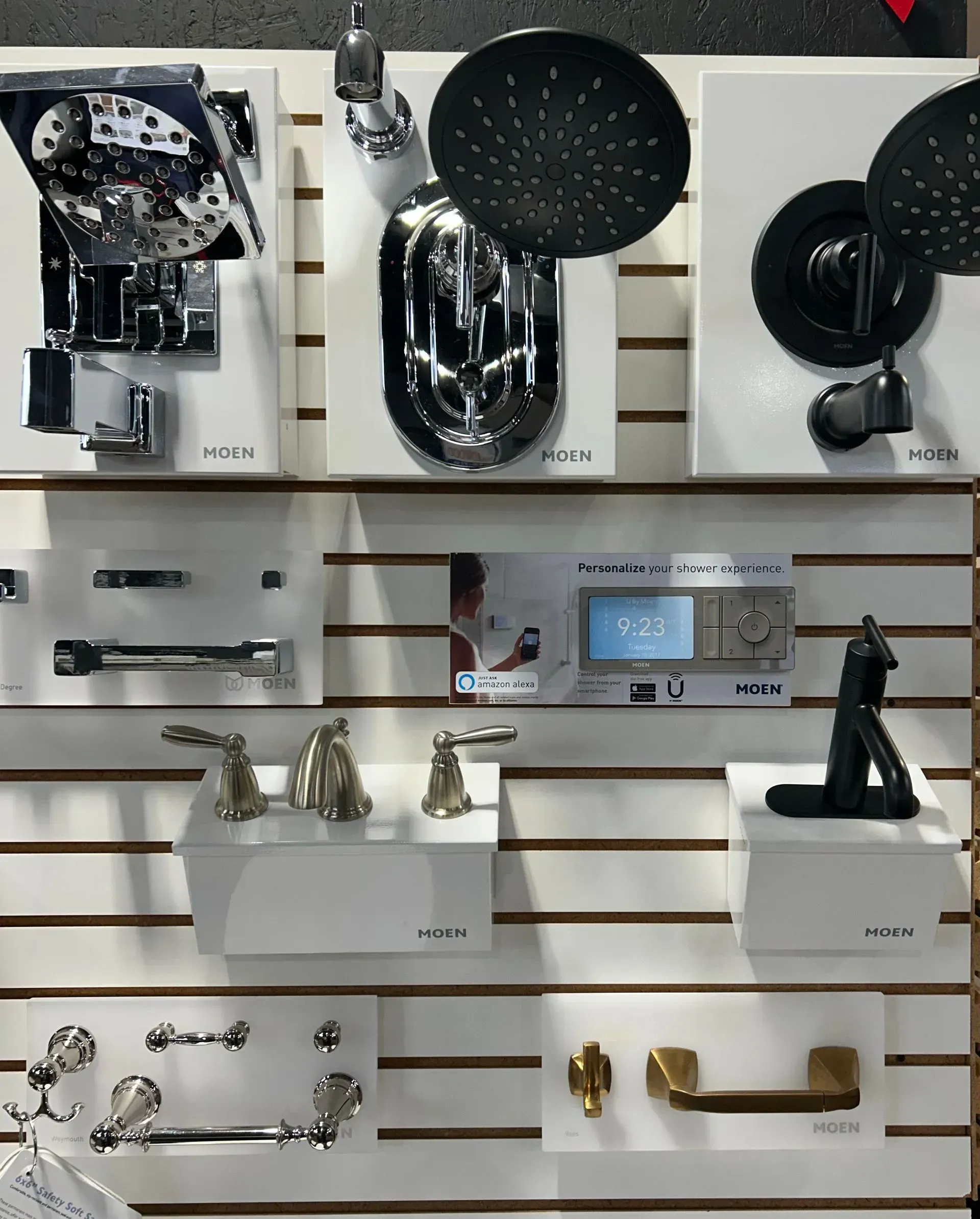 A wall with a variety of bathroom fixtures on it