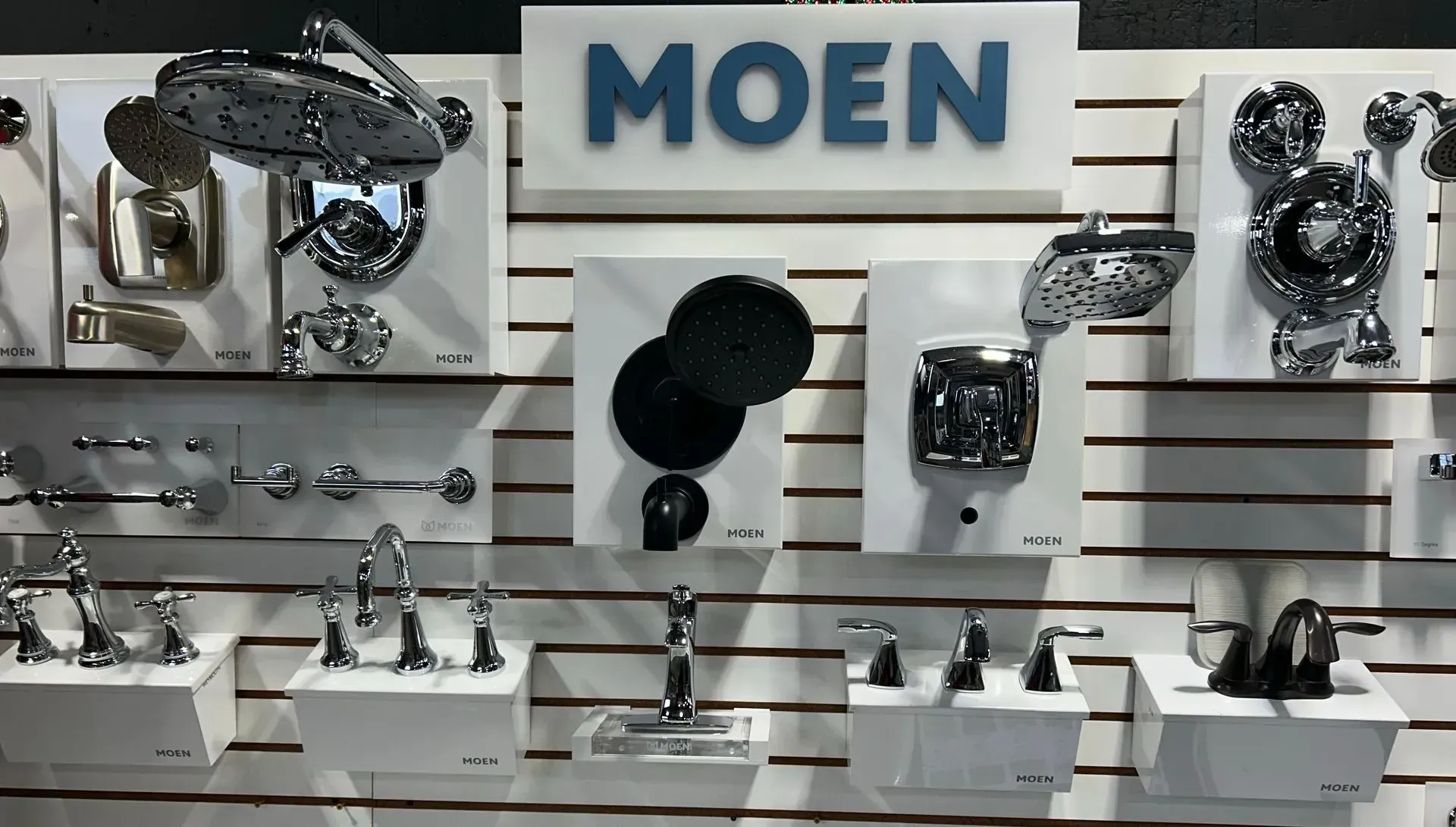 A wall with a sign that says moen on it