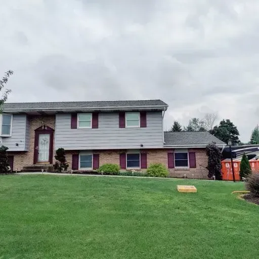 A large house with a lush green lawn in front of it.