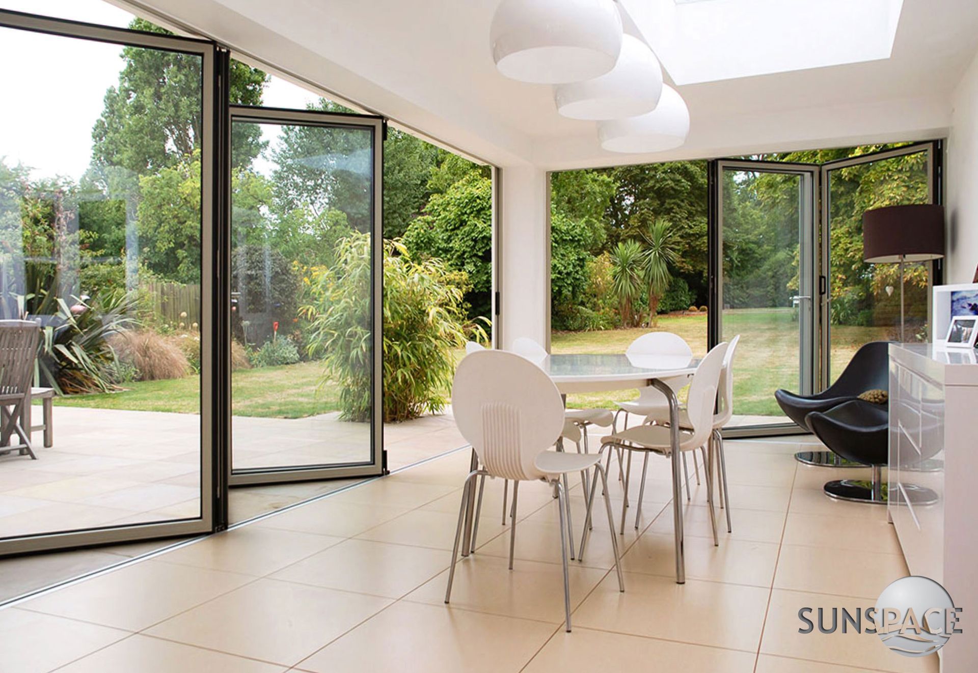 A dining room with a table and chairs and a sign that says sunspace